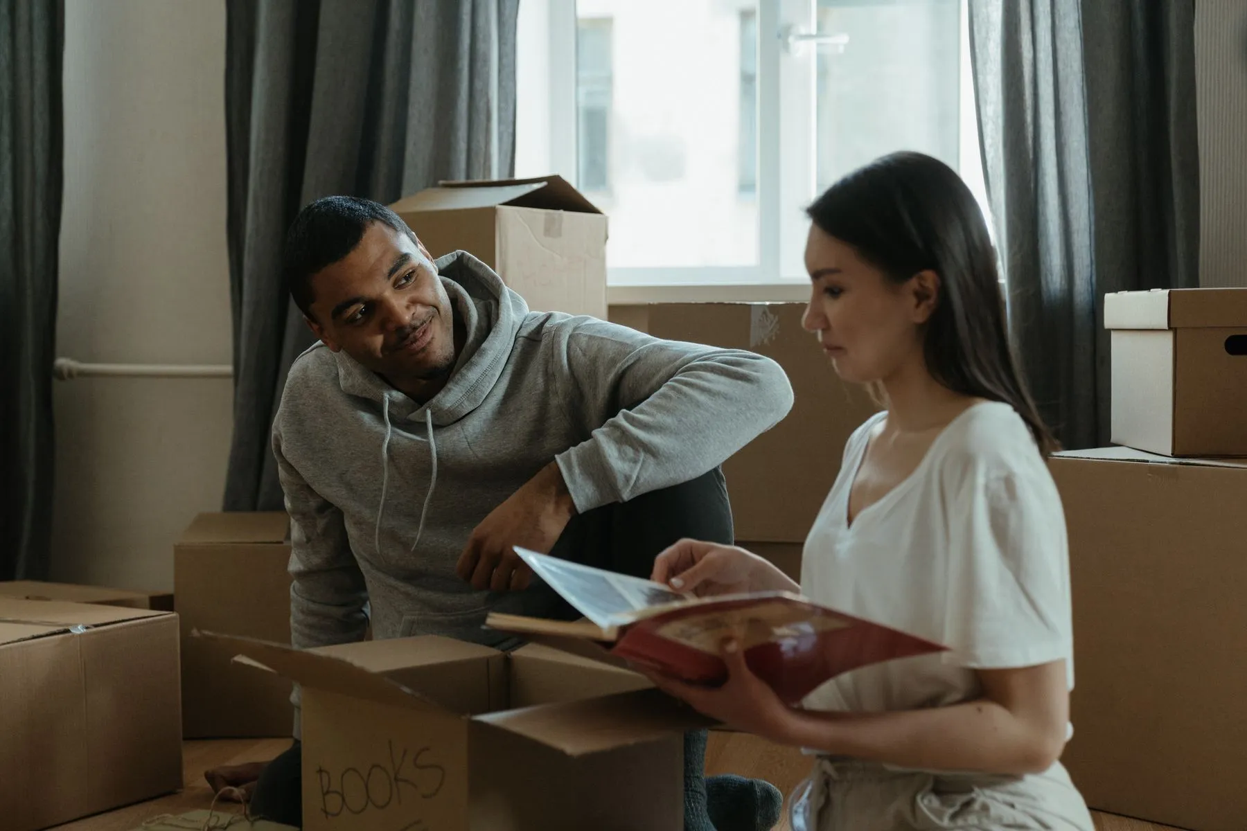 A couple unpacking moving boxes in a new home